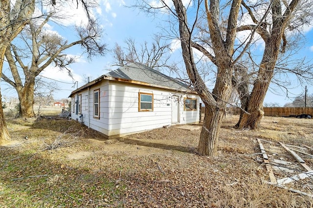 view of home's exterior with fence