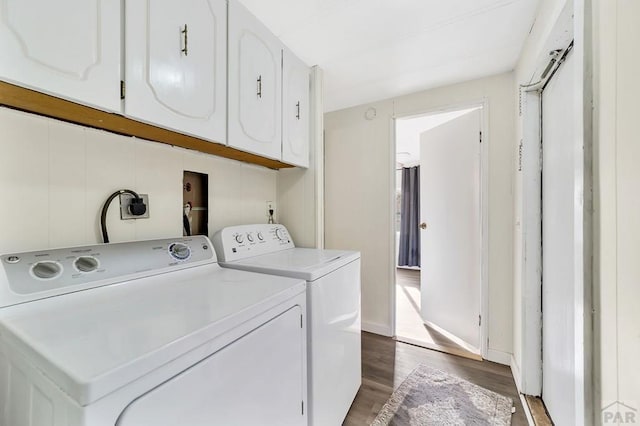 laundry room featuring dark wood-style floors, independent washer and dryer, cabinet space, and baseboards