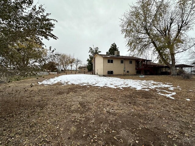 view of snow covered rear of property