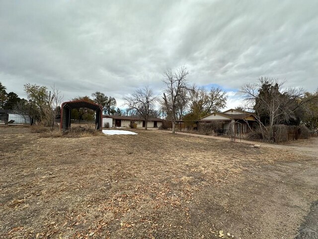 view of yard with a detached carport and a gazebo