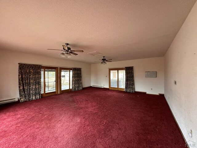 spare room featuring a textured ceiling, a baseboard heating unit, plenty of natural light, and a ceiling fan