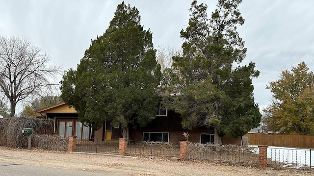 obstructed view of property featuring a fenced front yard