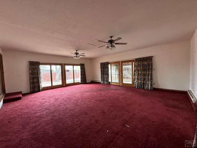 spare room with carpet, french doors, baseboard heating, a ceiling fan, and baseboards