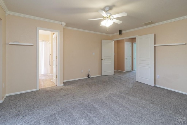 unfurnished bedroom with a ceiling fan, baseboards, carpet floors, crown molding, and connected bathroom