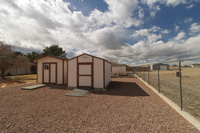 view of shed featuring fence