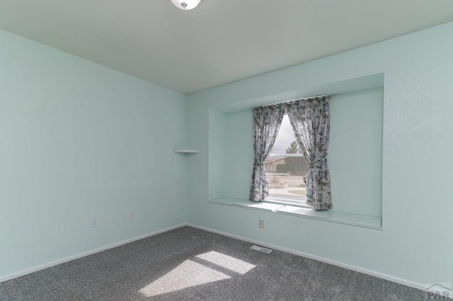 unfurnished room featuring carpet flooring, baseboards, and visible vents