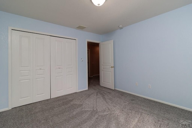 unfurnished bedroom featuring a closet, baseboards, carpet, and visible vents