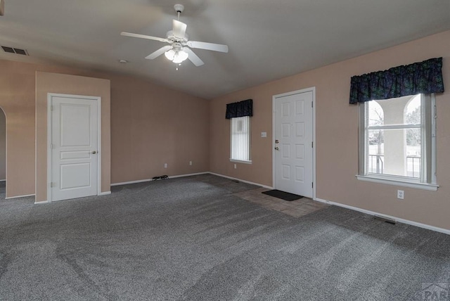 entrance foyer featuring arched walkways, visible vents, carpet flooring, and a ceiling fan