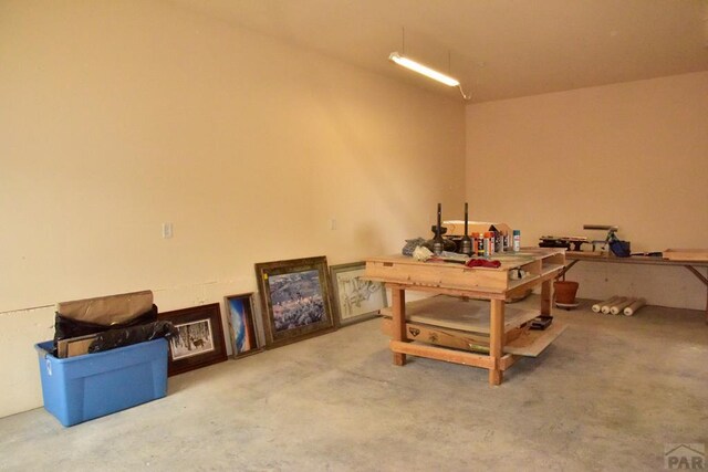 interior space featuring concrete floors and a workshop area