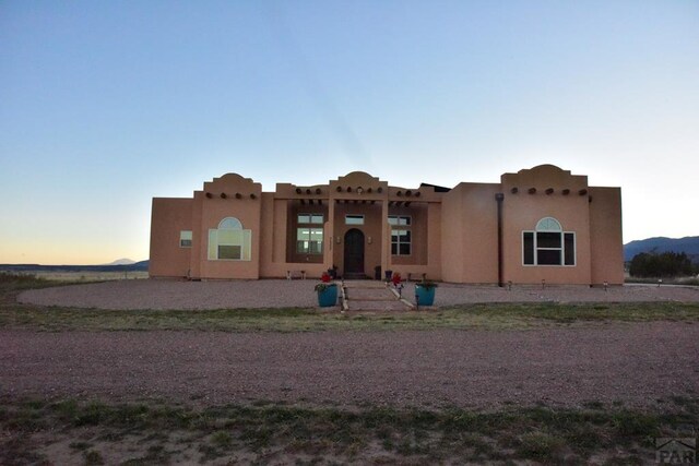 pueblo-style home with stucco siding