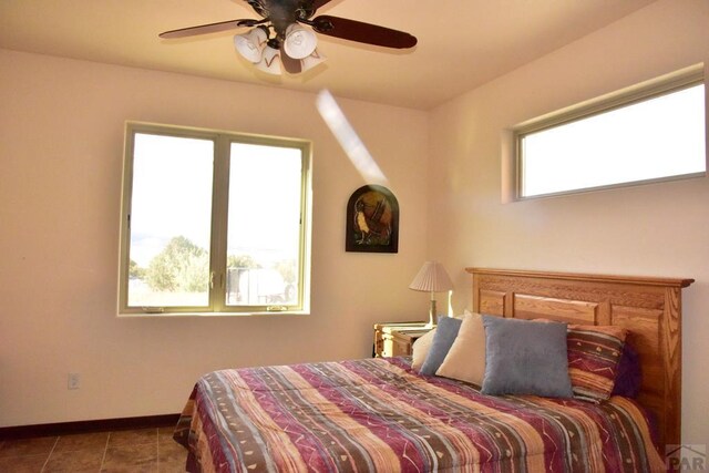 bedroom featuring tile patterned flooring, ceiling fan, and baseboards