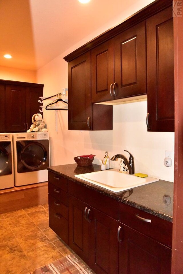 interior space featuring light tile patterned floors, washing machine and dryer, recessed lighting, a sink, and cabinet space