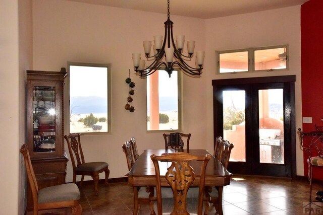 dining area featuring a chandelier and tile patterned floors