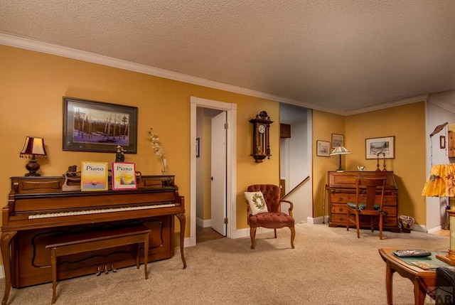 sitting room featuring a textured ceiling, crown molding, baseboards, and carpet floors