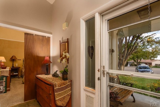 doorway featuring carpet floors