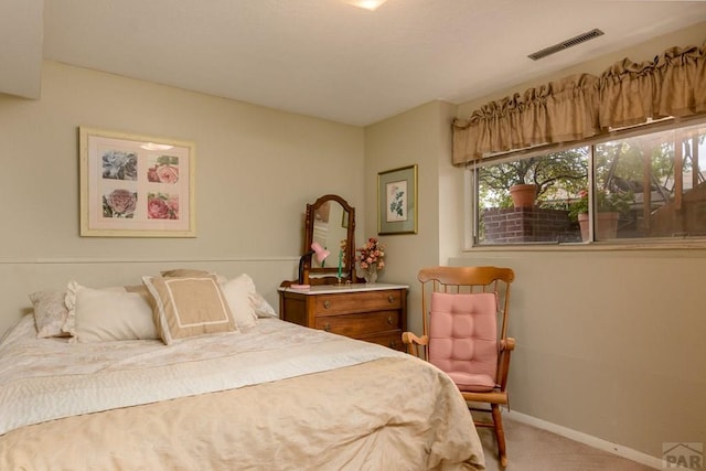 bedroom featuring baseboards, visible vents, and carpet