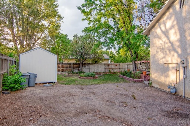 view of yard featuring a fenced backyard, a shed, and an outdoor structure