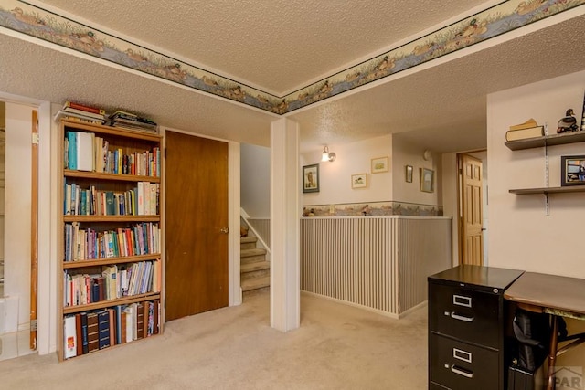home office with a textured ceiling and carpet floors