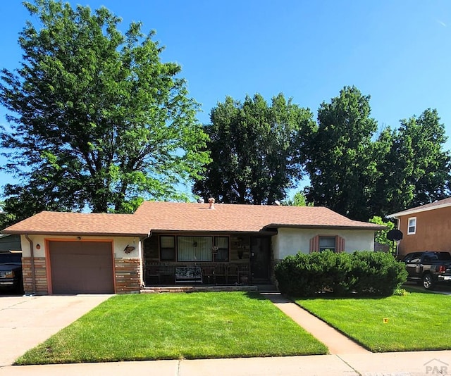 3219 Urban St, Pueblo, CO 81005 - single story home featuring a front lawn, an attached garage, concrete driveway, and covered porch