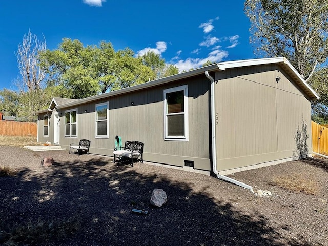 rear view of property with fence