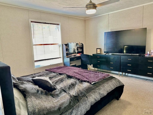 bedroom featuring ceiling fan, ornamental molding, and carpet