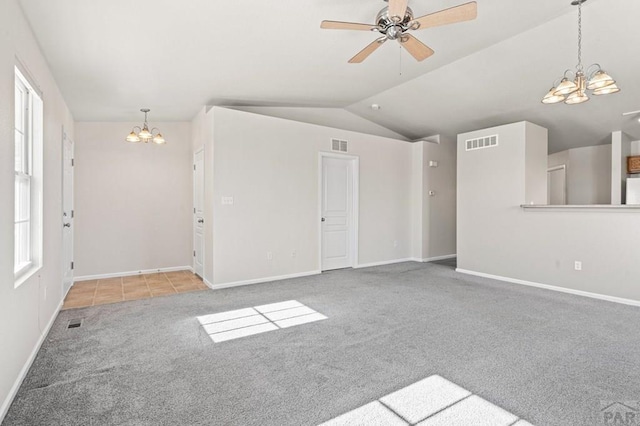 spare room with lofted ceiling, visible vents, and light carpet