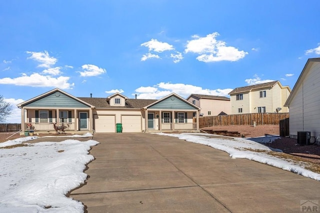 single story home with a garage, covered porch, fence, and concrete driveway