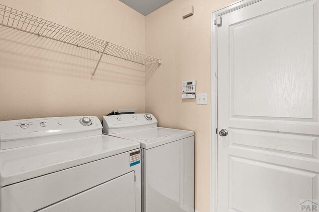 washroom featuring washer and dryer and laundry area