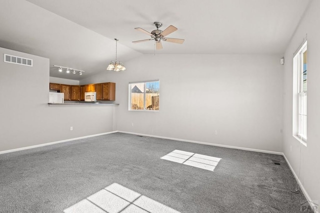 unfurnished living room with vaulted ceiling, carpet flooring, visible vents, and baseboards