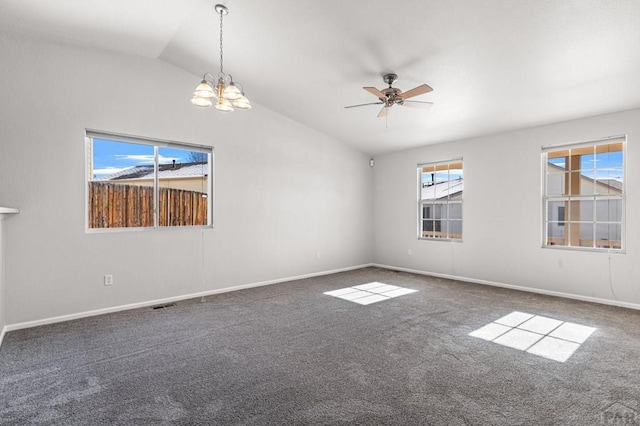 empty room with baseboards, dark carpet, vaulted ceiling, and ceiling fan with notable chandelier