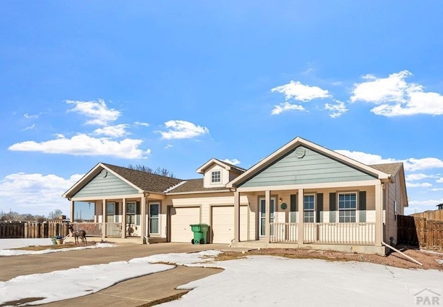 ranch-style home with an attached garage and covered porch