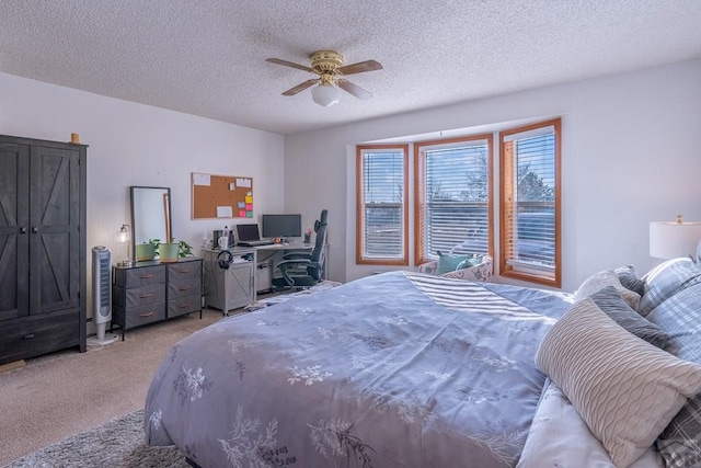 bedroom featuring light carpet, a textured ceiling, and a ceiling fan