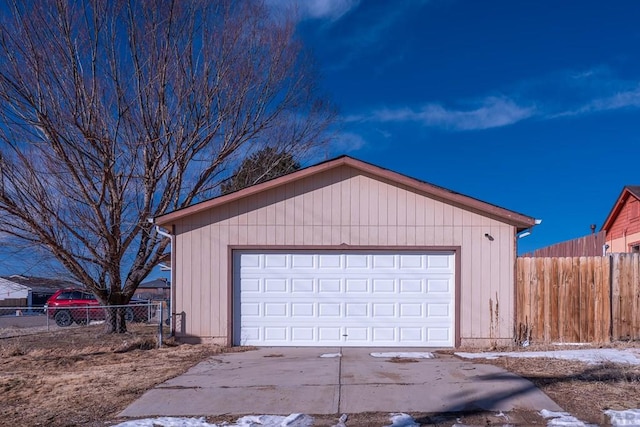 detached garage featuring fence