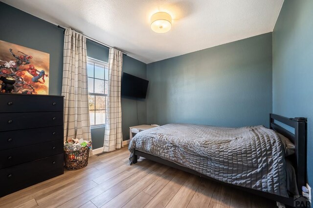 bedroom with light wood-type flooring