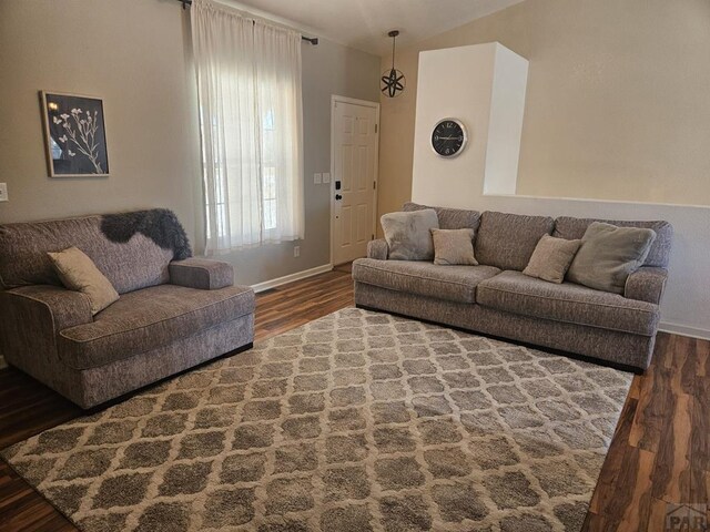 living room featuring dark wood finished floors and baseboards