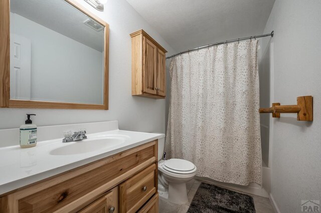 bathroom with visible vents, shower / bathtub combination with curtain, toilet, vanity, and tile patterned floors