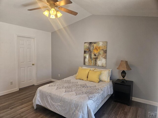 bedroom featuring dark wood-style floors, lofted ceiling, ceiling fan, and baseboards