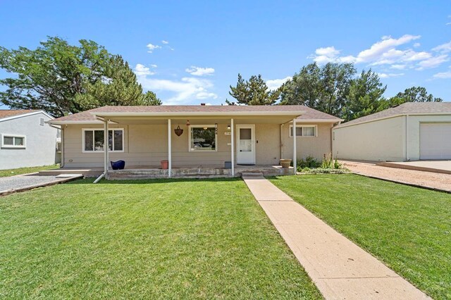 single story home with a front yard and covered porch