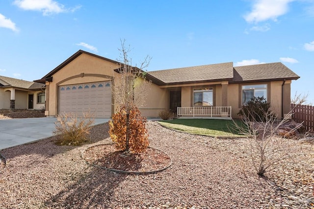 ranch-style home with concrete driveway, a shingled roof, an attached garage, and stucco siding