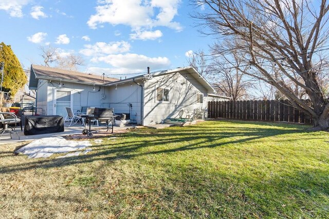 view of home's exterior featuring a patio area, fence, and a lawn