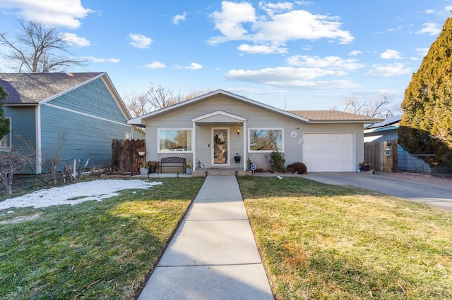 ranch-style house featuring an attached garage, fence, a front lawn, and concrete driveway