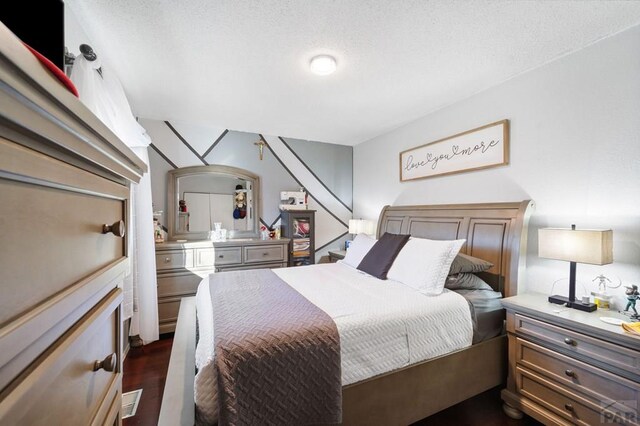 bedroom featuring dark wood finished floors