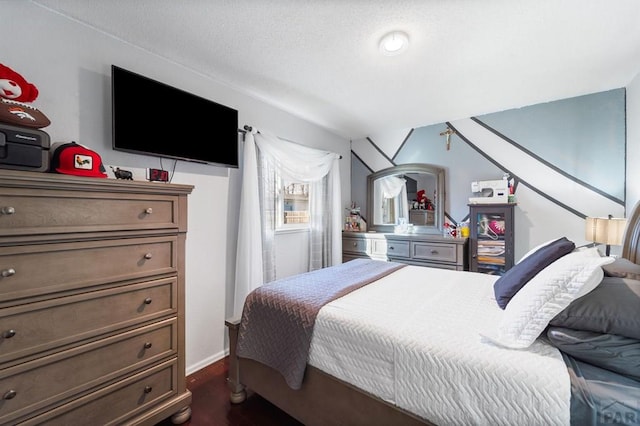 bedroom with dark wood-style floors and baseboards