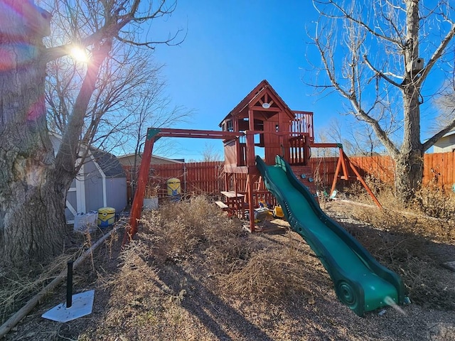 view of play area with a shed and fence