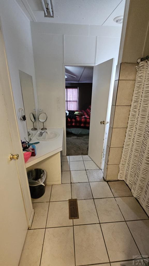 full bath featuring tile patterned flooring, visible vents, and vanity