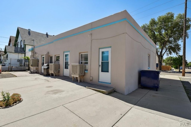 back of property with fence and stucco siding