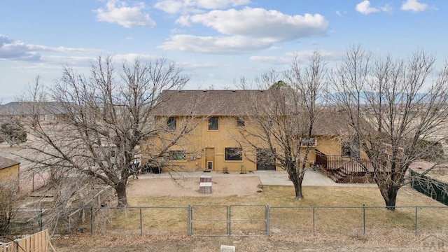 view of front of house with a patio area, fence private yard, a front yard, and a gate