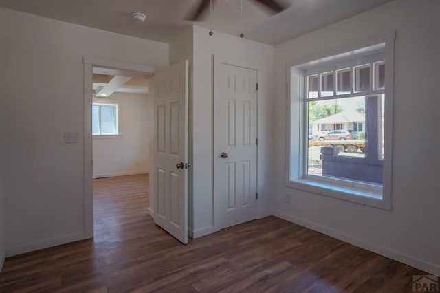 327/327.5 7th St, Walsenburg, CO 81089 - unfurnished bedroom with dark wood-style floors, baseboards, a ceiling fan, and a closet