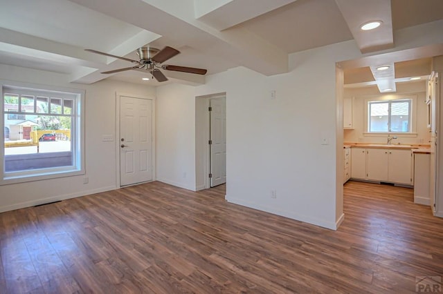 327/327.5 7th St, Walsenburg, CO 81089 - unfurnished living room with dark wood-style flooring, healthy amount of natural light, ceiling fan, baseboards, and recessed lighting