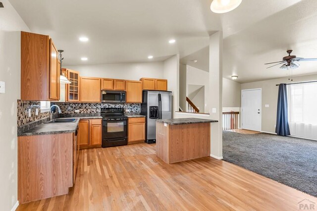 806 N Monarch Dr, Pueblo, CO 81007 - kitchen with black / electric stove, stainless steel refrigerator with ice dispenser, a sink, dark countertops, and lofted ceiling